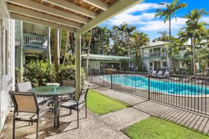 Enjoy a patio overlooking the pool at Coral Beach Noosa Resort
