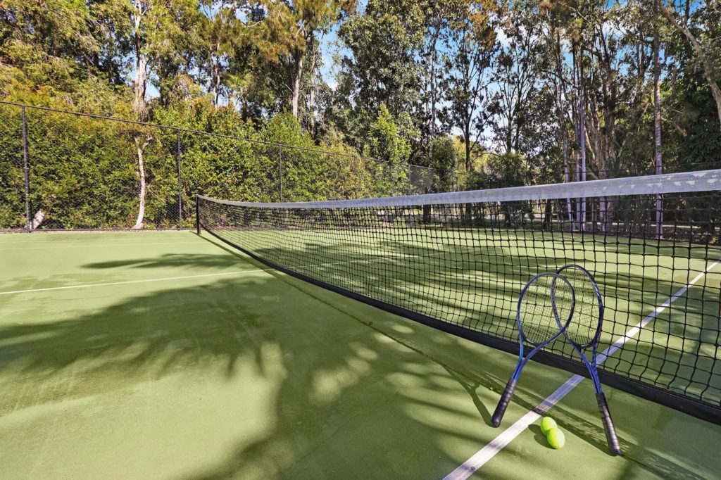 Full size tennis court at Coral Beach Noosa Resort