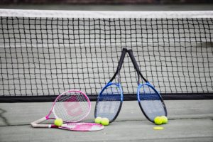 Enjoy a game of tennis at Coral Beach Noosa Resort